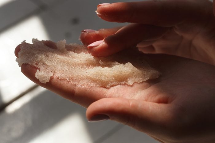 Oil salt scrub. Cosmetic surgery, hand peeling. Massage of female hands peeling preparation Spa and Wellness