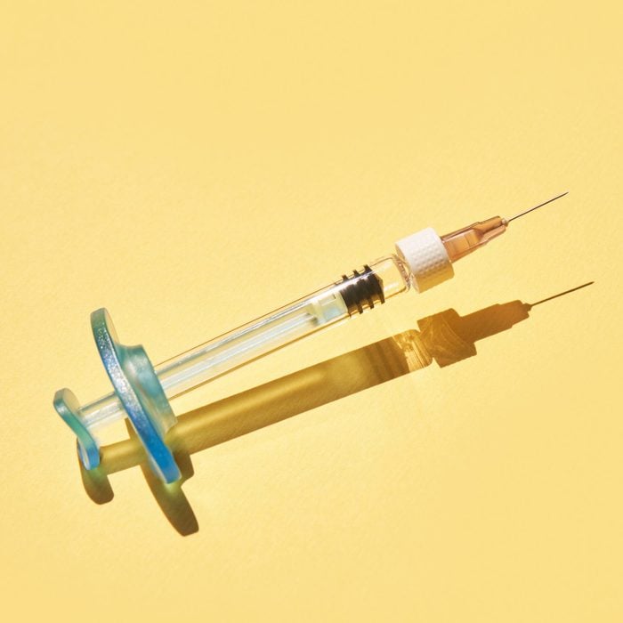 Syringe drug. Doctor injection vaccine. Hard shadow. Healthcare therapy