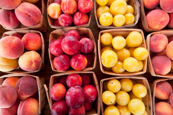 Ripe in season peaches and plums for sale at a farmers market