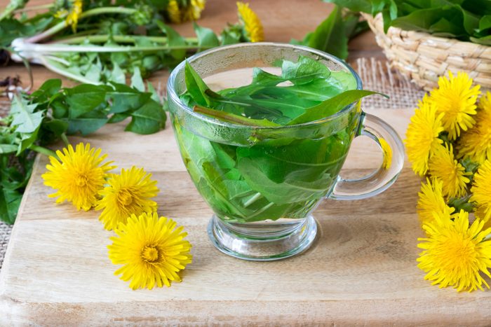 A cup of dandelion tea made from fresh leaves
