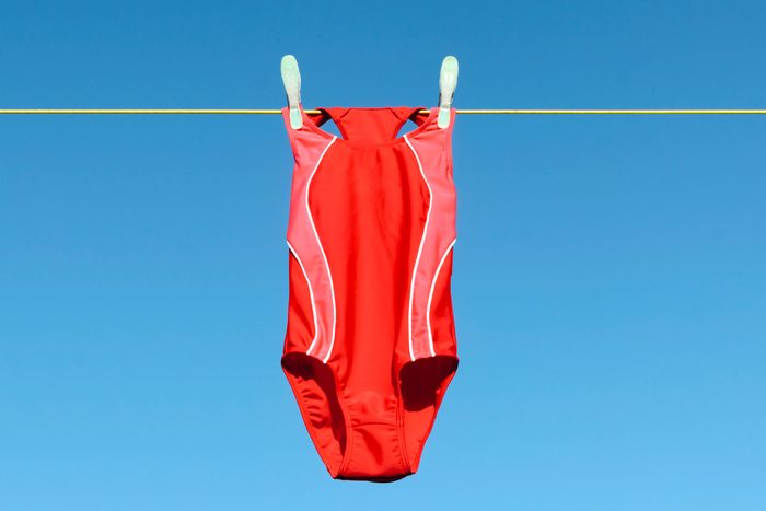 red swim suit hanging o na clothes line in the summer