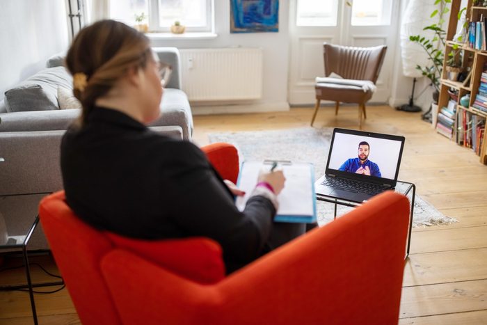 person talking to a therapist virtually using a laptop