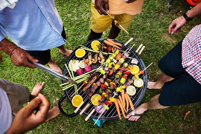 top view of a group of friends having a cookout and grilling healthy plant based foods and kabobs