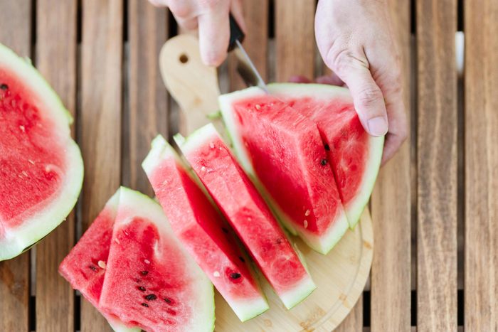 hand slicing watermelon