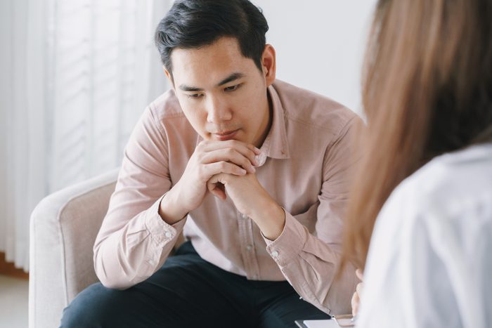 Male Asian patient with psychologist women examination consulting and psychotherapy by the physician in the clinic. psychiatrist concept