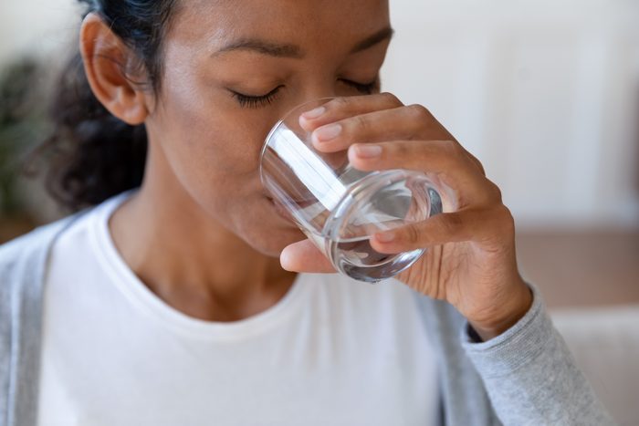 Close up of african american woman drinking water