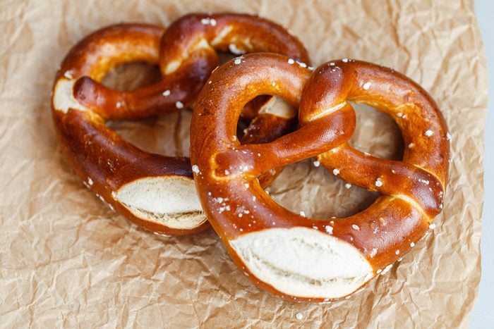 Two traditional soft Octoberfest pretzels on brown paper