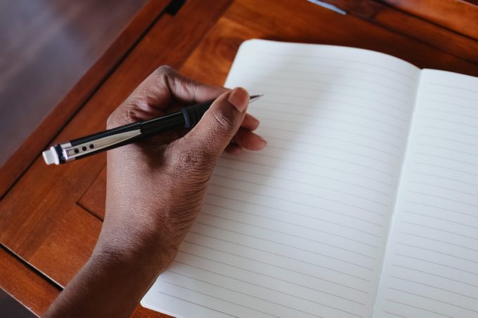 Woman Writes in Empty Notebook