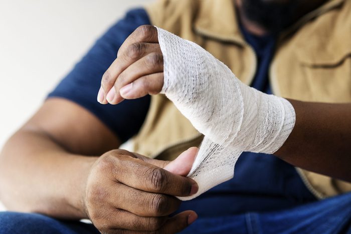 wrapping injured hand with bandage