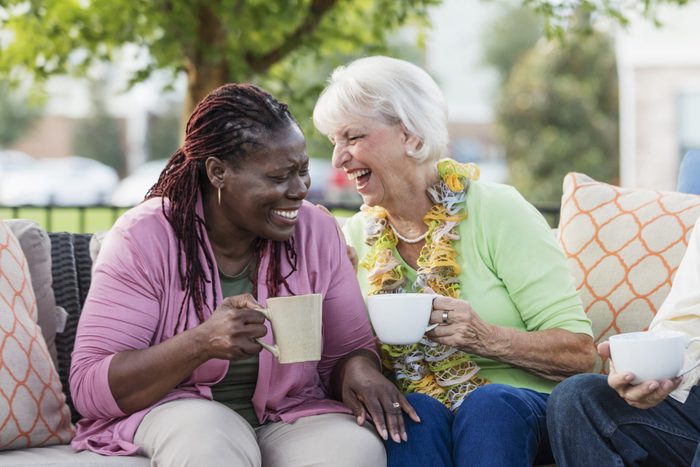 Senior woman, African-American friend laughing together