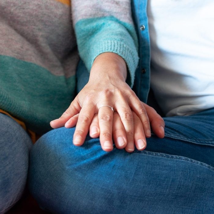 lesbian couple hands intertwined in close up shot