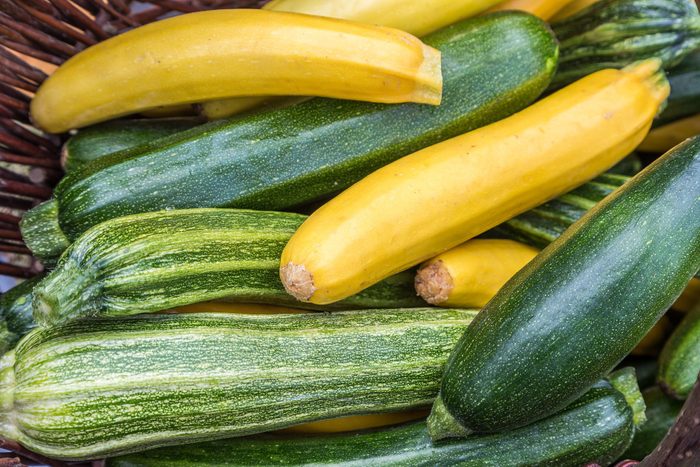 Courgettes zucchini marrow in a basked freshly picked on a farmers market day. Vivid green and yellow colors concept Concept for organic ecological homegrown healthy food