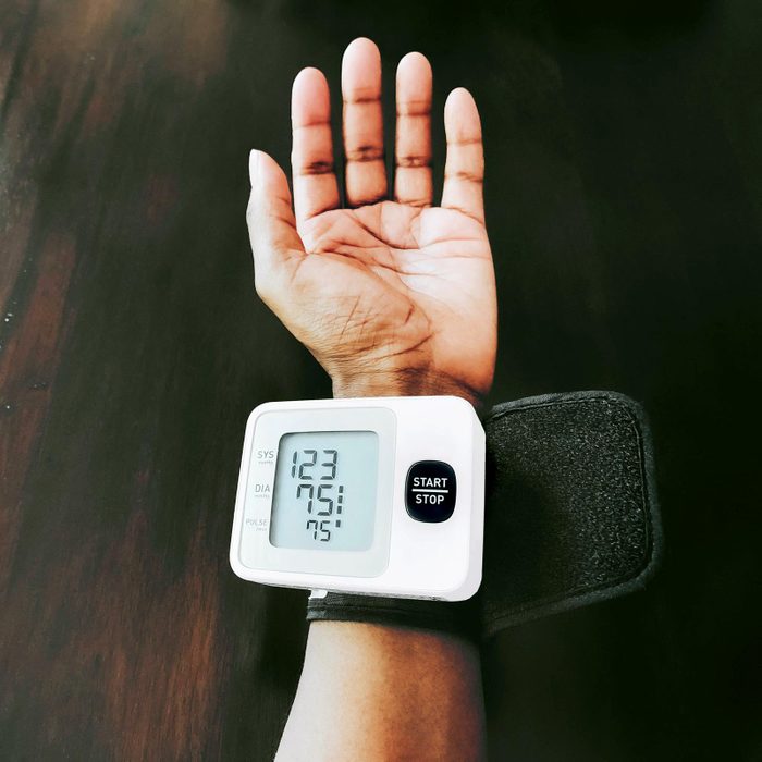 blood pressure monitor on a woman's arm demonstrating How To Read Your Blood Pressure