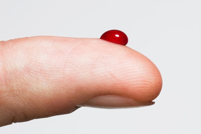 drop of blood on finger from testing blood sugar