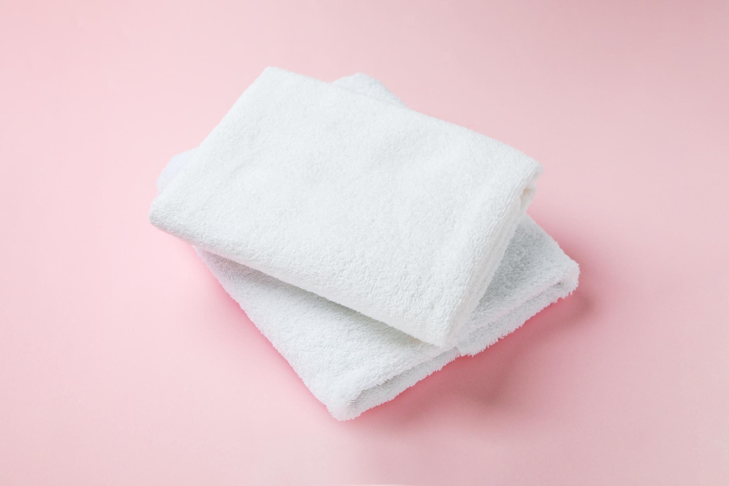 white towels on pink background