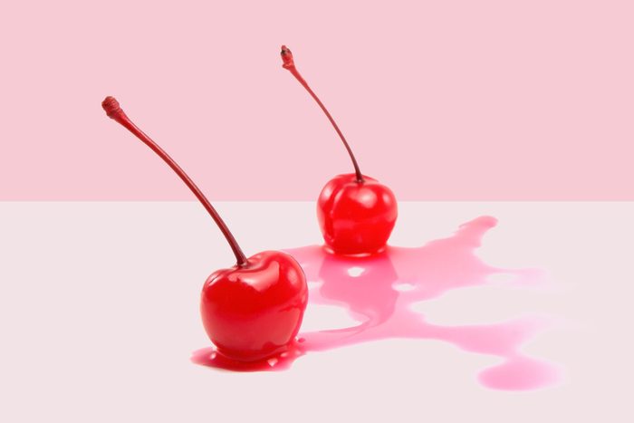 juicy maraschino cherries on a pink background