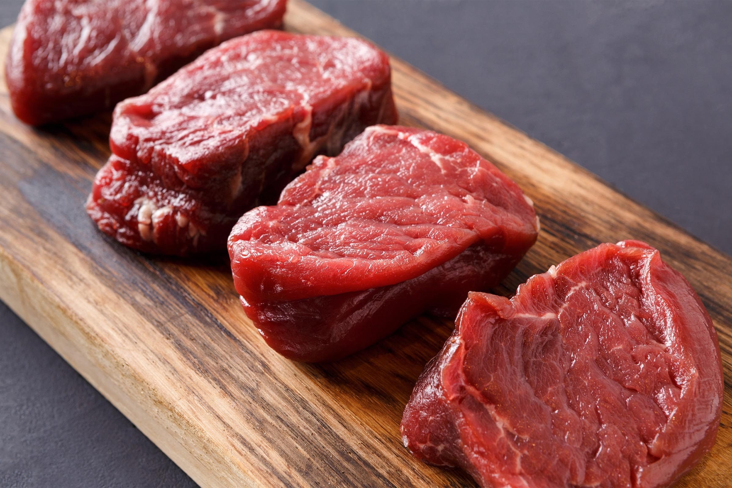 Lean steaks on a cutting board