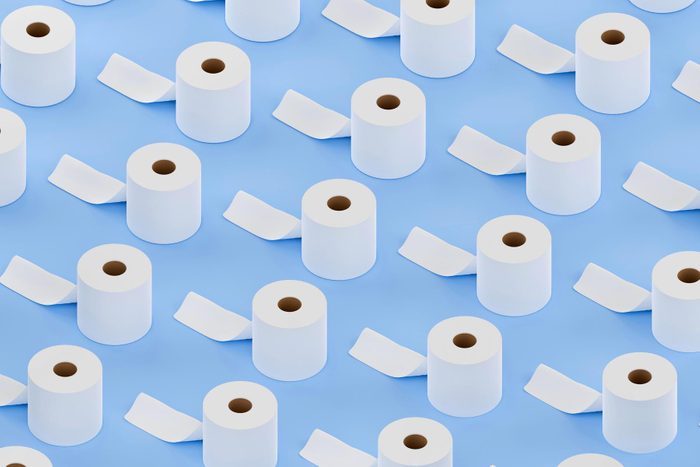 grid of toilet paper rolls on a blue background