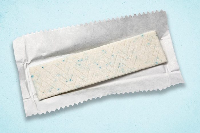 stick of chewing gum on a light blue textured background