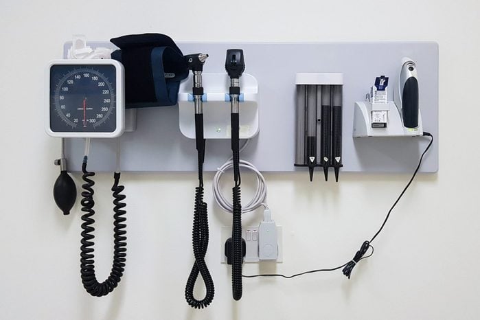 Standard doctor's office equipment mounted to a wall with copy space.