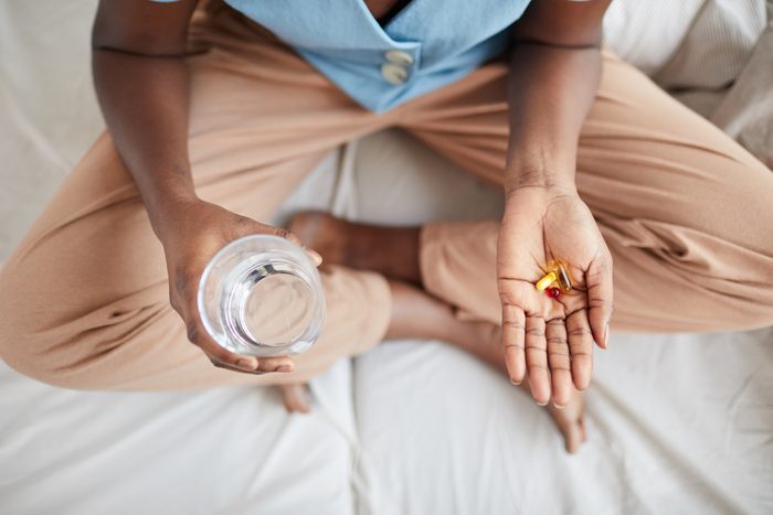 African-American Woman Taking Medication Top View