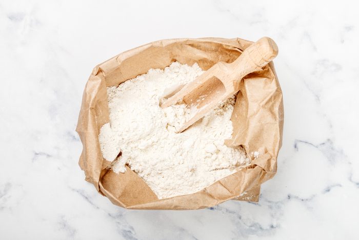 flour in a bag with a wooden scoop