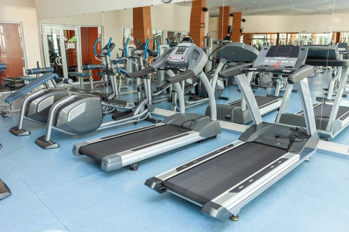 Interior of modern gym fitness room with treadmills