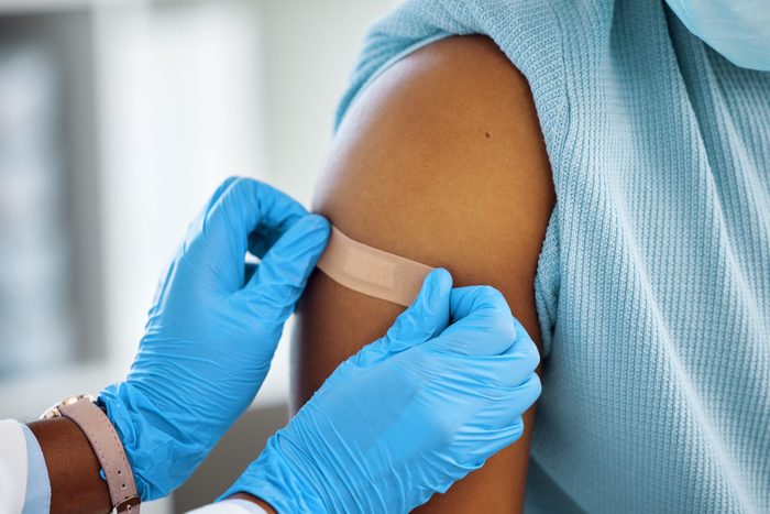 Shot of a doctor applying a plaster to her patients arm