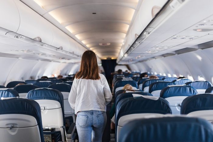 Girl leaving airplane's passenger cabin