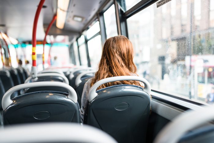 woman inside a bus in london travel alone