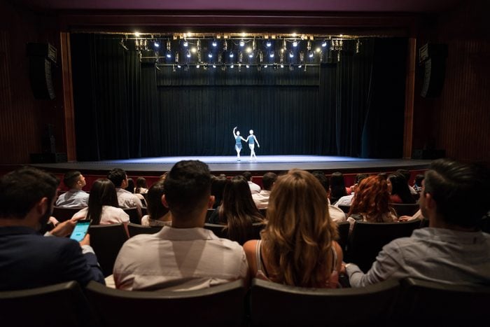 People at a theater looking at a dress rehearsal of ballet performing arts