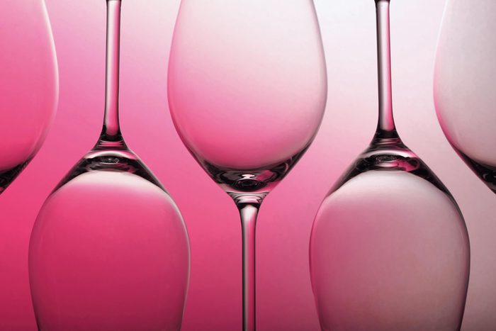 empty wine glasses on a pink background