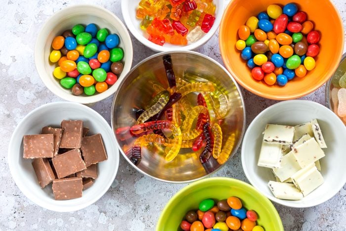 Overhead view of colorful candy and chocolate in bowls