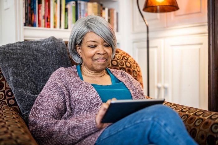 Senior woman using digital tablet in home environment