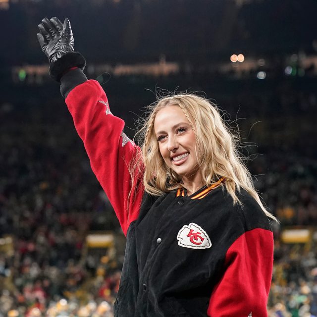 Brittany Mahomes, wife of Patrick Mahomes #15 of the Kansas City Chiefs , waves before the game between the Kansas City Chiefs and the Green Bay Packers at Lambeau Field