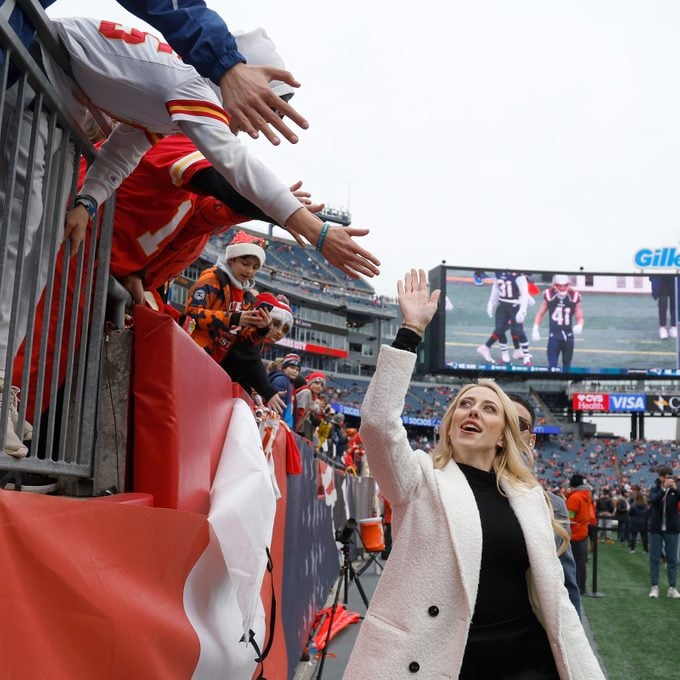 Brittany Mahomes waves to fans prior to a game between the Kansas City Chiefs and the New England Patriots at Gillette Stadium on December 17, 2023 in Foxborough, Massachusetts