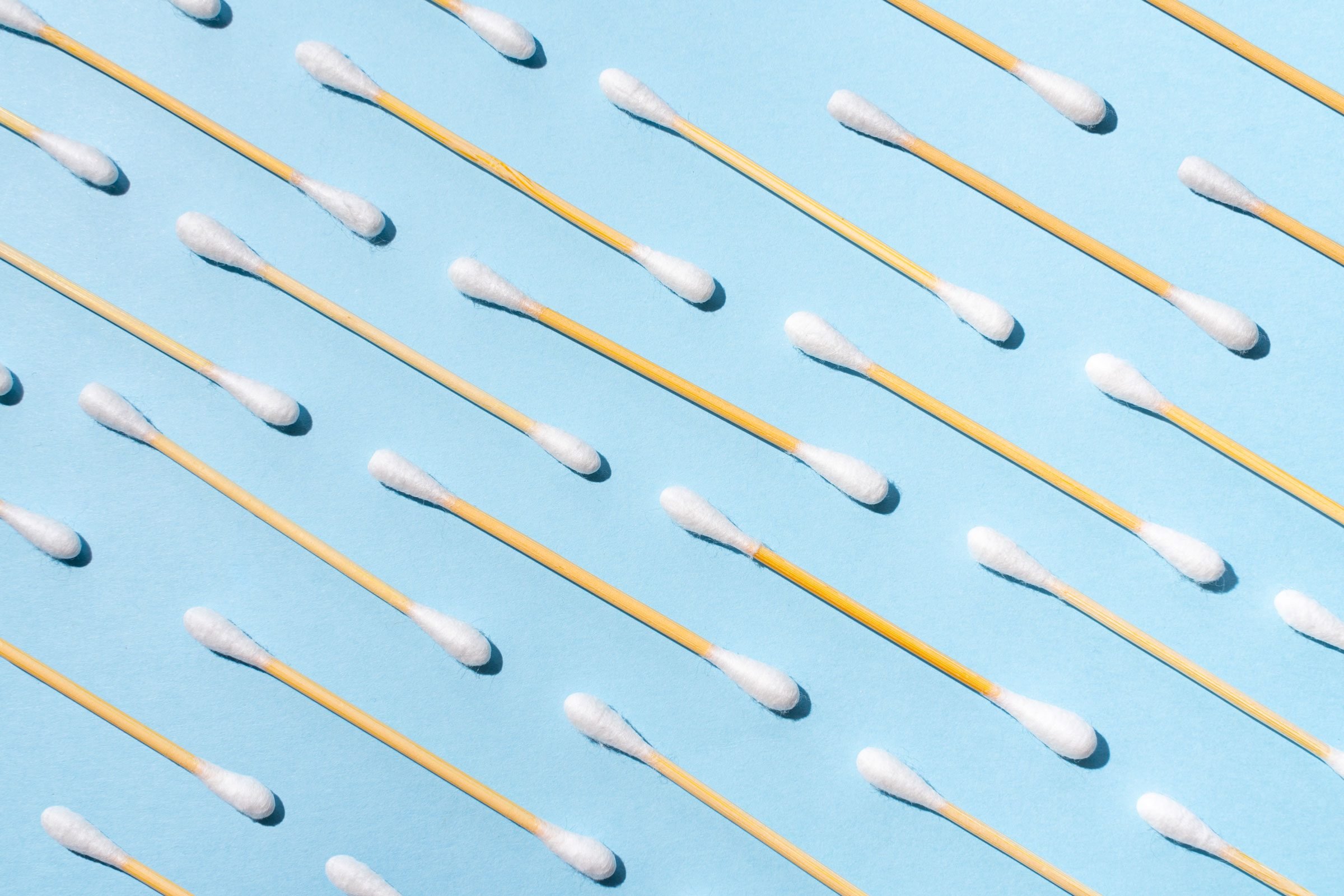 pattern of q-tips on a blue background
