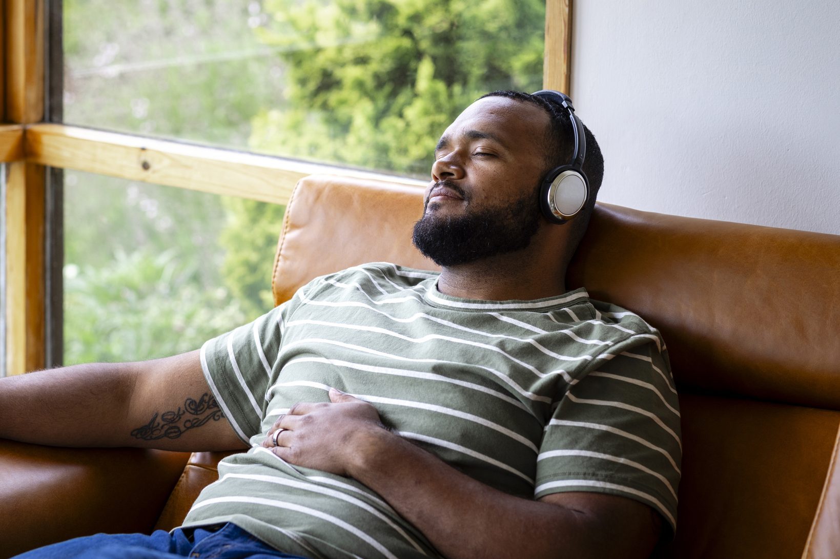 man listening to music and sitting with eyes closed