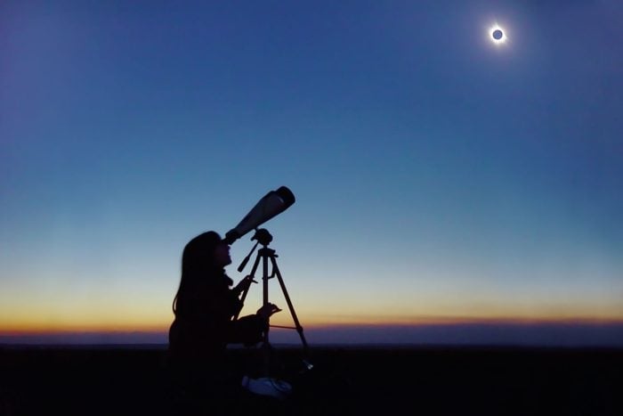 Young Woman Observing Total Solar Eclipse